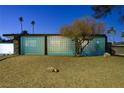 Midcentury modern home with a unique blue block wall facade at night at 1558 Aztec Way, Las Vegas, NV 89169