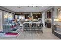 Modern kitchen featuring stainless steel appliances, dark cabinetry, and an island with seating at 232 Errogie St, Henderson, NV 89012