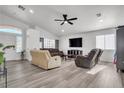 Spacious living room with hardwood floors and a ceiling fan at 2419 Country Valley Ct, North Las Vegas, NV 89030