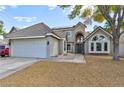 Two-story house with gray exterior, attached garage, and walkway at 2632 Cathedral Ln, Las Vegas, NV 89108