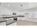 Bright kitchen with white cabinets, dark countertops, and stainless steel appliances at 2812 Dotted Wren Ave, North Las Vegas, NV 89084