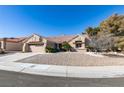 Single-story home with a red tile roof and landscaped front yard at 2905 Legend Dr, Las Vegas, NV 89134