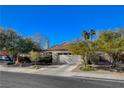 Single story house with a white garage door and mature trees at 301 Salinas Dr, Henderson, NV 89014