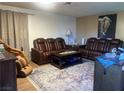 Living room featuring leather furniture and a large rug at 3484 Twilight Star Dr, Las Vegas, NV 89117