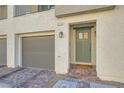 Townhome entry with modern door, brick walkway, and attached garage at 3772 Brilliant Sunset St, Las Vegas, NV 89129