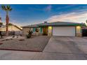 Ranch style home with landscaped yard and attached garage at 4475 El Carnal Way, Las Vegas, NV 89121