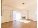 Living room with laminate floors, fireplace, and sliding door at 4730 E Craig Rd # 2028, Las Vegas, NV 89115