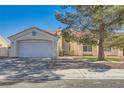 Charming single-story home featuring a well-maintained front yard, a two-car garage, and a beautiful terracotta roof at 5624 Silver Belle St, Las Vegas, NV 89149