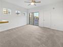 Bright living room featuring neutral carpeting and sliding door access to balcony at 5965 Palmilla St # 2, North Las Vegas, NV 89031