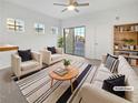 Virtually staged living room with comfy seating and a modern coffee table at 5965 Palmilla St # 2, North Las Vegas, NV 89031