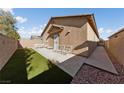 Artificial turf backyard with patio furniture and a side gate at 6333 Supernova Hill St, North Las Vegas, NV 89031