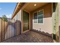 Front entry with a green door and paved walkway at 6333 Supernova Hill St, North Las Vegas, NV 89031