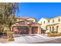 Two-story house with three-car garage and stone accents at 6737 Fast Brook Ct, North Las Vegas, NV 89084