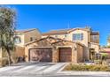 Two-story house with three-car garage, stone accents, and landscaping at 6737 Fast Brook Ct, North Las Vegas, NV 89084