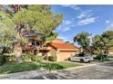 Beautiful home with a tile roof, lush landscaping, and a two-car garage at 7536 Spanish Bay Dr, Las Vegas, NV 89113