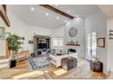 Bright living room with hardwood floors, a stone fireplace, and high ceilings at 7536 Spanish Bay Dr, Las Vegas, NV 89113