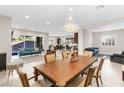 Open dining room with large table and chandelier at 7576 Windy Meadow Ave, Las Vegas, NV 89178