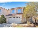 Two-story house with a two-car garage and well-maintained landscaping at 7645 Rustic Galleon St, Las Vegas, NV 89139