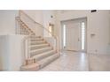 Bright entryway with tiled floors and a carpeted staircase at 8236 Horseshoe Bend Ln, Las Vegas, NV 89113