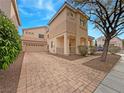 Two-story house with driveway and mature trees in front at 8971 Dallas Ridge Ave, Las Vegas, NV 89178