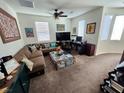 Spacious living room with sectional sofa and large TV at 9545 Belmont Bay Ave, Las Vegas, NV 89148