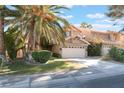 Two-story house with attached garage and palm trees at 2112 Brighton Shore St, Las Vegas, NV 89128