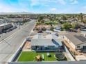 This aerial shows the property's backyard with a manicured lawn, play set, lounge chairs, and trampoline at 2690 Diamante Cir, Las Vegas, NV 89121