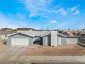 Single-story home featuring neutral tones, a two-car garage, and low maintenance landscaping at 2690 Diamante Cir, Las Vegas, NV 89121