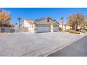 Two-story house with a three-car garage and gated driveway at 4101 Birchmont St, Las Vegas, NV 89130