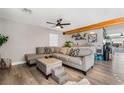 Spacious living room with sectional sofa and wood floors at 4818 El Tesoro Ave, Las Vegas, NV 89121