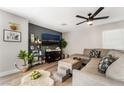 Modern living room featuring a large TV and house plants at 4818 El Tesoro Ave, Las Vegas, NV 89121