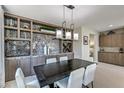 Elegant dining area with built-in cabinetry and modern light fixture at 4884 E Cactus Canyon Dr, Pahrump, NV 89061