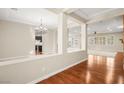 Open floor plan with hardwood floors, high ceilings, and views to kitchen at 7258 Sashaying Spirit Ct, Las Vegas, NV 89131