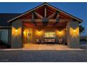 Night view of a home's front porch with a wood pergola and lighting at 8068 Buena Vida St, Las Vegas, NV 89166