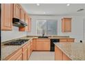 Kitchen with gas range, light wood cabinets, and granite countertops at 8212 Opal Falls St, North Las Vegas, NV 89085