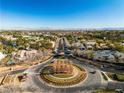 Community entrance with circular drive and surrounding homes at 9032 Park Forest Ct, Las Vegas, NV 89134