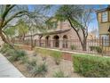 Two-story house with front yard landscaping and a brown fence at 10079 S Riley St, Las Vegas, NV 89178