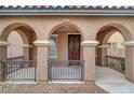 Covered entryway with arched columns and a wooden door at 10079 S Riley St, Las Vegas, NV 89178