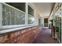 Brick front porch with metal railing and entry door at 1229 S 9Th St, Las Vegas, NV 89104