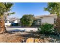 Front yard with palm trees and a gravel driveway at 1229 S 9Th St, Las Vegas, NV 89104