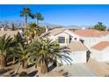 Two-story house with tile roof and attached garage, mountain backdrop at 1608 Council Bluff Ln, North Las Vegas, NV 89031