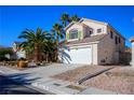 Two-story house with attached garage and desert landscaping at 1608 Council Bluff Ln, North Las Vegas, NV 89031