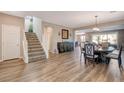 Open concept floor plan featuring a dining room area with wooden floors and adjacent staircase at 1610 Dire Wolf Avenue, North Las Vegas, NV 89084