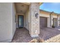 Front entry with light-colored brick and modern door at 210 Bella Noche St, Las Vegas, NV 89138