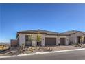 Single-story home with two-car garage and desert landscaping at 210 Bella Noche St, Las Vegas, NV 89138