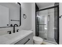 Updated bathroom with gray vanity, black fixtures, and glass shower at 2157 Wagonwheel Ave, Las Vegas, NV 89119