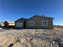 New construction home showcasing a neutral exterior and gravel landscaping at 3414 Mount Charleston Dr, Pahrump, NV 89048