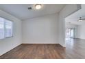 Simple dining area with hardwood floors and adjacent living room at 3514 Old Course St, Las Vegas, NV 89122