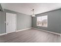 Bedroom featuring wood-look floors, a ceiling fan, and a window at 3802 Terrazzo Ave, Las Vegas, NV 89115