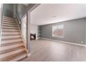 Open living room with a fireplace, built-in shelves, staircase, and wood-look floors at 3802 Terrazzo Ave, Las Vegas, NV 89115